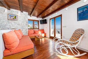 a living room with a couch and a table at Brela Seaview Apartment with Swimming Pool & Parking in Brela