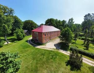 an aerial view of a large brick building with a red roof at Rozulas skola in Rozula
