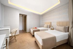 a hotel room with two beds and a table at Begovina in Marmaris