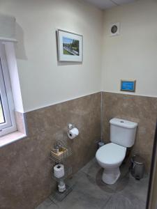 a bathroom with a white toilet in a room at Ardgay in Fort Augustus +23 photos