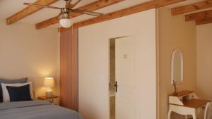 a bedroom with a bed and a ceiling fan at LE petit CHABO in Saint-Maigrin