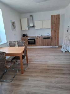 a kitchen and dining room with a table and chairs at Ferienwohnung Wagner in Stegersbach +14 photos