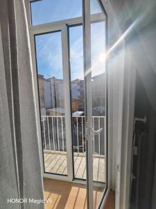 a sliding glass door with a view of a balcony at La Dimora di Tuya Superior in Naples