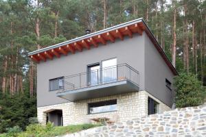 a house with a balcony on top of it at Chata Nola Slapy in Křečovice