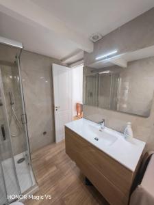 a bathroom with a sink and a shower at La Dimora di Tuya Superior in Naples