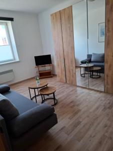 a living room with a couch and a mirror at Ferienwohnung Wagner in Stegersbach