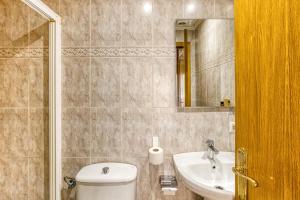 a bathroom with a toilet and a sink and a mirror at Hostal La Barretina in Figueres +22 photos