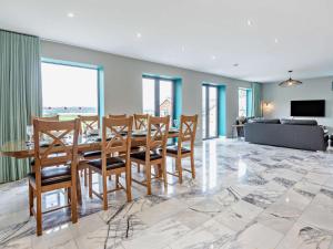 a dining room with a table and chairs at 4 Bed in Talsarnau oc-96164 in Talsarnau