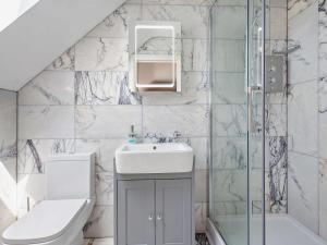 a bathroom with a sink and a toilet and a shower at 4 Bed in Talsarnau oc-96164 in Talsarnau +25 photos