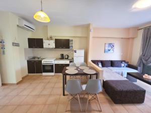 a living room with a couch and a table and chairs at Dalia Mare in Flogita
