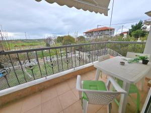 a balcony with a table and chairs and a view at Dalia Mare in Flogita