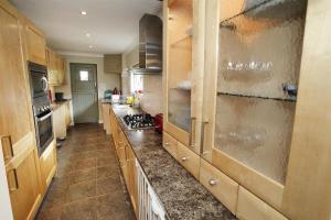 a kitchen with wooden cabinets and a stove top oven at 2 Bed in Gower oc-hh411 in Parkmill