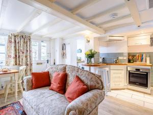 a living room with a couch and a kitchen at 1 Bed in Presteigne oc-53667 in Presteigne +21 photos