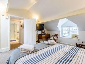 a bedroom with a large bed with towels on it at 1 Bed in Presteigne oc-53667 in Presteigne