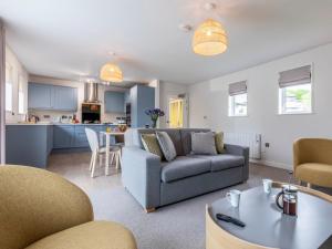 a living room with a couch and a table at 2 Bed in Saltash oc-87709 in St. Mellion