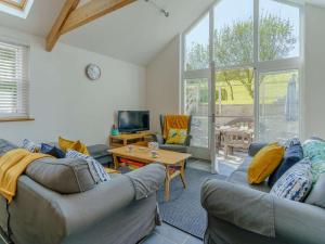 a living room with two couches and a table at 3 Bed in Pembroke oc-82584 in Lamphey