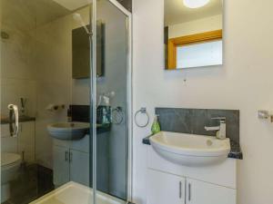 a bathroom with a glass shower and a sink at 3 Bed in Pembroke oc-82584 in Lamphey +13 photos