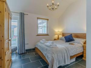 a bedroom with a bed with towels on it at 3 Bed in Pembroke oc-82584 in Lamphey