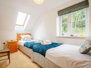 two twin beds in a bedroom with a window at 4 Bed in Corwen oc-88868 in Corwen