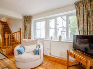 a living room with a chair and a television at 4 Bed in Corwen oc-88868 in Corwen