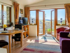 a living room with a table and a couch at 1 Bed in Lampeter oc-43288 in Tregaron
