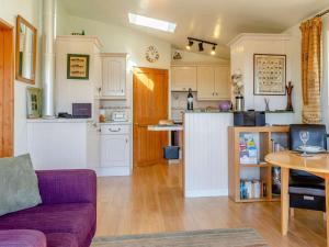 a living room with a couch and a kitchen at 1 Bed in Lampeter oc-43288 in Tregaron