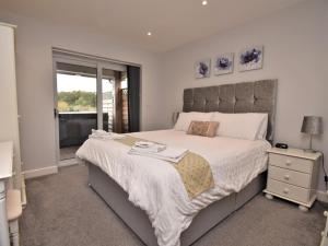 a bedroom with a large bed and a window at 4 Bed in Oswestry oc-74110 in Kinnerley