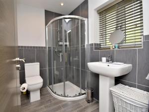 a bathroom with a shower and a toilet and a sink at 4 Bed in Oswestry oc-74110 in Kinnerley +14 photos