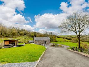 an estate with a barn on a grassy hill at 4 Bed in Llandysul oc-89422 in Cwm-pengraig