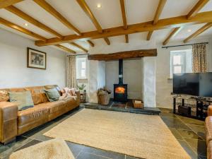 a living room with a couch and a fireplace at 4 Bed in Llandysul oc-89422 in Cwm-pengraig
