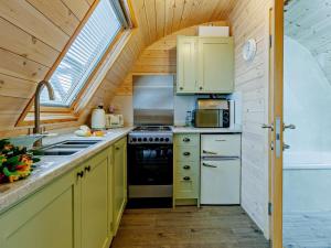 a kitchen with yellow cabinets and a sink and a window at 2 Bed in Shrewsbury oc-93396 in Leighton +12 photos