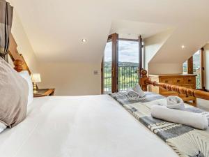 a bedroom with a large bed and a large window at 2 Bed in Corwen oc-77351 in Corwen