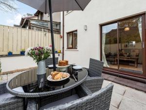 a table and chairs with an umbrella on a patio at 2 Bed in Narberth oc-tc84026 in Narberth