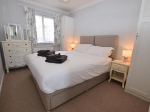 a bedroom with a white bed with towels on it at 2 Bed in Narberth oc-tc84026 in Narberth
