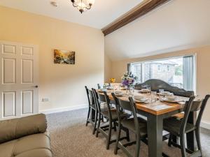 a dining room with a table and chairs at 4 Bed in Bala oc-75288 in Llandderfel