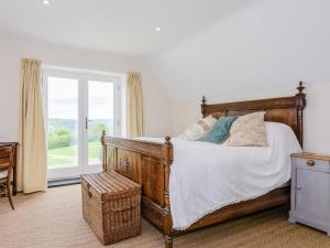 a bedroom with a bed and a large window at 4 Bed in Llandinam oc-51651 in Llandinam