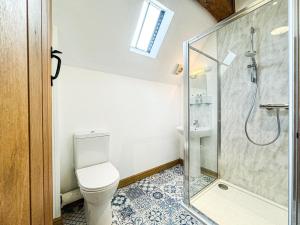a bathroom with a toilet and a glass shower at 4 Bed in Newtown oc-86784 in Bettws Cedewain +27 photos