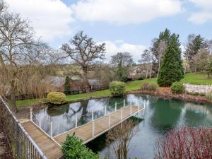 a wooden bridge over a river in a park at 4 Bed in Newtown oc-86784 in Bettws Cedewain
