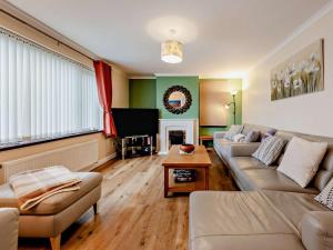 a living room with a couch and a tv at 5 Bed in Llanybydder oc-75907 in Llanwenog