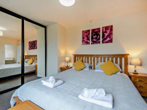a bedroom with a large bed with two towels at 5 Bed in Llanybydder oc-75907 in Llanwenog