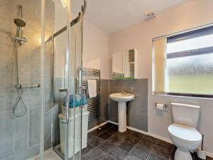 a bathroom with a toilet and a sink and a shower at 5 Bed in Llanybydder oc-75907 in Llanwenog +33 photos