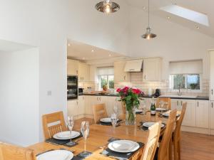 a kitchen and dining room with a table and chairs at 4 Bed in Llandysul oc-66640 in Llandysul