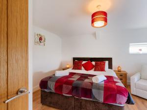 a bedroom with a bed with red pillows at 4 Bed in Llandysul oc-66640 in Llandysul