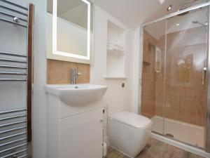 a bathroom with a sink and a toilet and a shower at 4 Bed in Llandysul oc-66640 in Llandysul