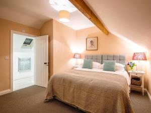 a bedroom with a large bed with green pillows at 5 Bed in Whitchurch oc-77696 in Whitchurch