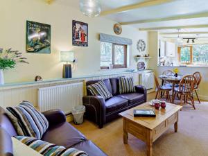 a living room with a couch and a table at 2 Bed in Lampeter oc-43293 in Tregaron