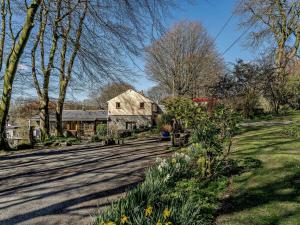 a house with a yard with flowers and trees at 2 Bed in Lampeter oc-43293 in Tregaron