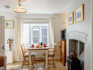 a living room with a table and a fireplace at 1 Bed in Presteigne oc-55285 in Presteigne