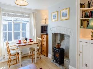 a living room with a table and a fireplace at 1 Bed in Presteigne oc-55285 in Presteigne