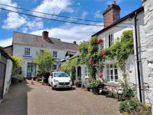 a street with white houses and a white car at 1 Bed in Presteigne oc-55285 in Presteigne